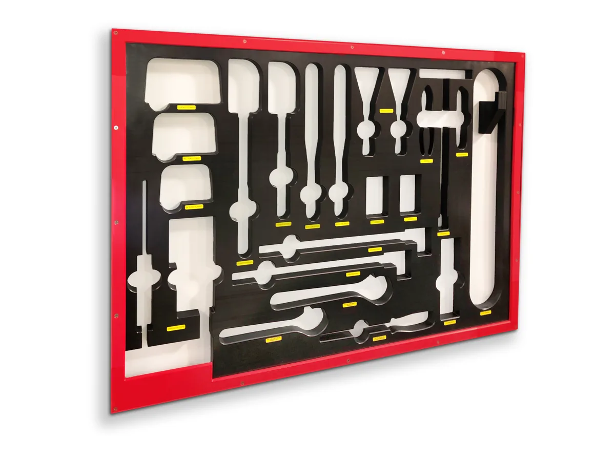 Wall-mounted shadowboard with two-tone tool cutouts
